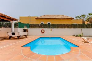 a swimming pool in the backyard of a house at Villa Relax Deluxe Private Pool Corralejo By Holidays Home in Corralejo