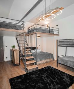 a bedroom with two bunk beds and a staircase at Apartmánový dům Sklípek in Trutnov