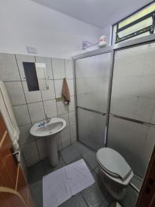 a bathroom with a shower and a toilet and a sink at Studio GT in São Carlos