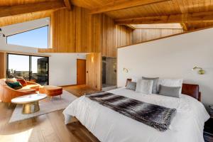 a bedroom with a large bed and a living room at Breakers Retreat in Sea Ranch