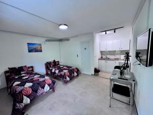 a room with two beds and a table in it at Apartments / Studio Matka in Matka