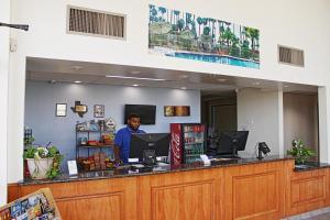 a man is standing at a counter in a store at Victoria Palms Inn and Suites in Donna