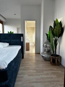 a bedroom with a bed and a vase with a statue at Luxury PENTHOUSE at the Historical Centre with free parking in Bratislava