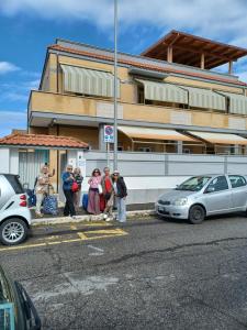 a group of people standing outside of a building at Mondo House in Fiumicino