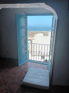 an open door to a balcony with a view of the ocean at Pension El Torreon in Mojácar