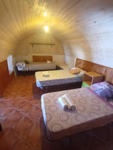 a room with three beds in a room with a ceiling at Pension El Torreon in Mojácar