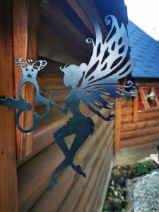 a metal sculpture of a woman dancing with a butterfly at La cabane du Nuton Ardennais in Tournes
