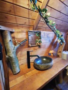 a wooden table with a bowl on top of it at La cabane du Nuton Ardennais in Tournes