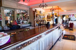 a bar with a large wooden counter top at The Belfray Country Inn in Derry Londonderry