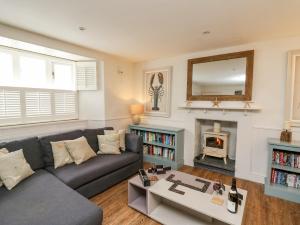 a living room with a couch and a fireplace at Tan y Craig in Haverfordwest