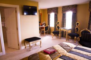 a bedroom with a bed and a table and chairs at The Belfray Country Inn in Derry Londonderry +63 photos