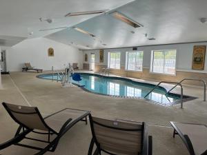 a large swimming pool in a building with chairs at Quality Inn & Suites Red Wing in Red Wing