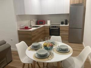 a kitchen with a table with a bowl of fruit on it at HYP - Los Geranios in Redondela