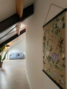 a living room with a painting on the wall at Boerderij appartement De Casterie in Bornerbroek