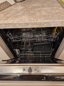 an oven with a rack of dishes inside of it at Centro apartamentai in Panevėžys