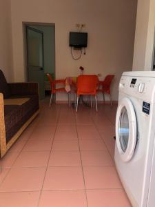 a living room with a washing machine on a tiled floor at Beachside Apartments Smajlaj in Velipojë