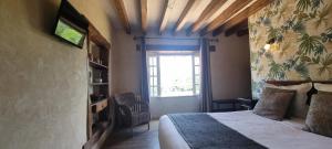 a bedroom with a bed and a window at Domaine de la Courbe Hôtel & Spa in Le Lude
