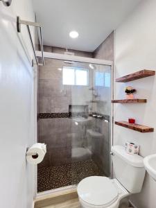 a bathroom with a shower and a toilet at Las Mariposas Mini Suites in Rosarito
