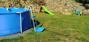 a small playground with a slide and a swing set at Chalupa u Martina in Vápenice