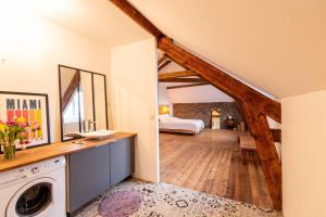 a large room with a bed and a washing machine at Maison, appartement type Triplex atypique de charme in Saint-Brieuc
