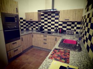a kitchen with a sink and a counter with fruit on it at CASA ALEGRIA in Algodonales +11 photos