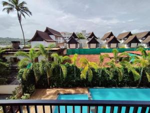 a view from the balcony of a resort at Ripples:Pool facing/RiverView/7 mins to Coco Beach in Nerul +22 photos