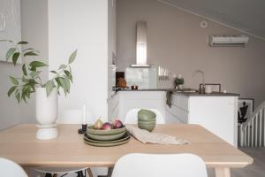 a kitchen with a table with a bowl of fruit on it at Arctic Homes - Unique Town House in Tromsø