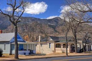 a house on a street with a mountain in the background at Historic Home w/Pikes Peak Views in Colorado Springs