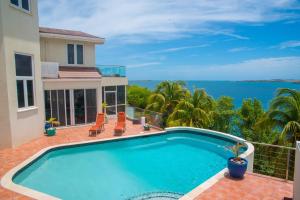 a swimming pool with a view of the ocean at Marks Reef in Lance aux Épines