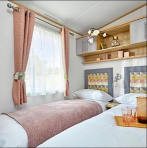 1 Schlafzimmer mit 2 Betten und einem Fenster in der Unterkunft Platinum Holiday Home by the Sea in Whitstable