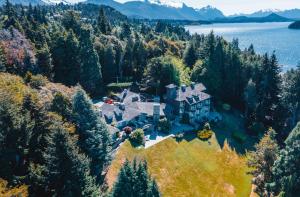 an aerial view of a house on a hill with trees at La Cascada Casa Patagónica by DON in San Carlos de Bariloche