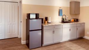 a kitchen with a refrigerator and a counter top at Summerwind Studios in Fort Myers