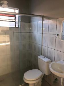 a bathroom with a toilet and a sink at CASA TEMPORADA PRADO-BA in Prado