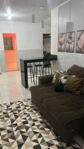 a living room with a couch and a table at CASA TEMPORADA PRADO-BA in Prado