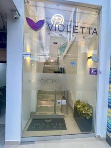 a window of a store with a sign on it at HOTEL VIOLETTA Cereté in Cereté