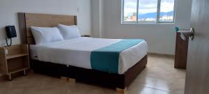 Voodi või voodid majutusasutuse Hotel Royal Cid Bogota toas