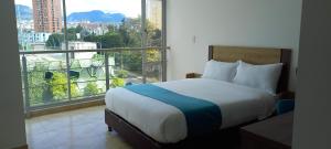 Voodi või voodid majutusasutuse Hotel Royal Cid Bogota toas