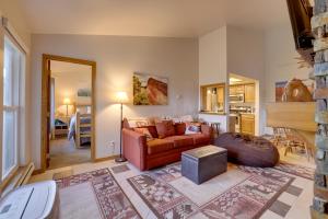 a living room with a couch and a table at Ski-InandSki-Out Brian Head Condo with Pool Access! in Brian Head