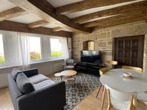 a living room with a couch and a table at Villa Ster et Mer in Plobannalec-Lesconil