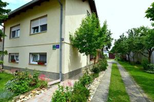 a house with a garden in front of it at Štefanija Apartmani in Nedelišće