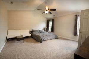 a bedroom with a bed and a ceiling fan at Beautiful home near Marine Corps base in Jacksonville