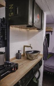 a kitchen counter with a sink and a stove at Vojenský bunker in Bratislava