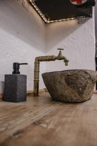 a bathroom with a stone sink in a room at Vojenský bunker in Bratislava