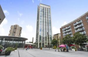 a tall glass building in a city with buildings at Ontario Point Flat double room in London