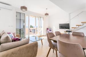 a living room with a table and chairs at Apartments Aleksandar in Petrovac na Moru