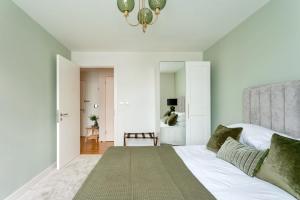a bedroom with a bed and a chandelier at Calm Zen Oasis, In Iconic London Olympic Park in London