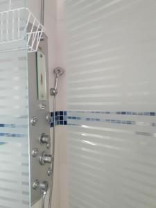 a shower with a glass door in a bathroom at Hotel Boutique Babilonia Manizales in Manizales