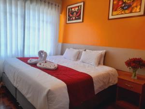 Postel nebo postele na pokoji v ubytování HOSTAL CASA INKAS
