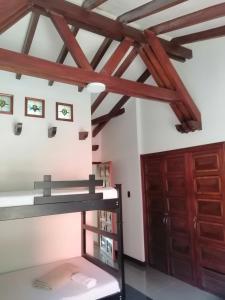 a room with a bunk bed and wooden beams at Hotel Boutique Babilonia Manizales in Manizales