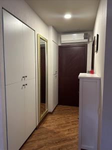 a hallway with a closet and a door and a mirror at Lovely studio by the sea with a terrace in Chakvi